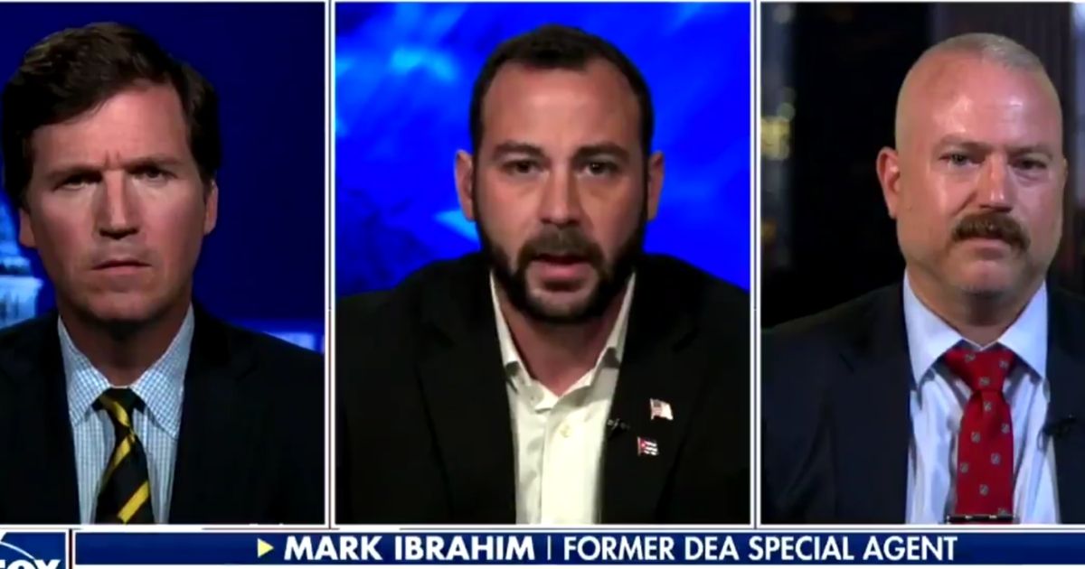 Former DEA agent Mark Ibrahim, center, speaks with Fox News host Tucker Carlson, left, and attorney Darren Richie concerning the charges he is facing for being outside of the Capitol on Jan. 6.