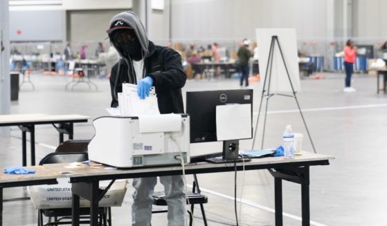Election officials count votes for Fulton County on Jan. 6, 2021, in Atlanta.