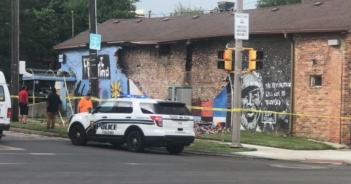 Police corner off a private building in Toledo, Ohio, after a painted mural of George Floyd was reportedly struck by lightning on Tuesday.