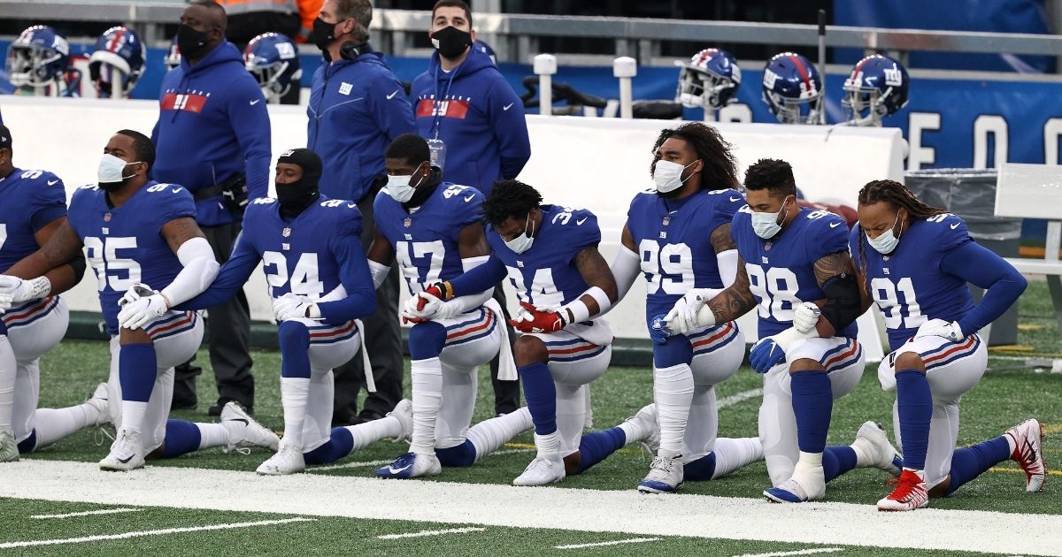 New York Giants players kneel during the national anthem prior to their game against the Dallas Cowboys at MetLife Stadium on Jan. 3.