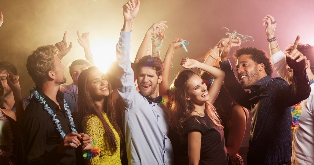 This stock photo portrays a group of friends dancing to music. Greece announced Saturday that music will be banned around the clock until the end of the month on the popular tourist island of Mykonos in response to an increase in COVID cases.