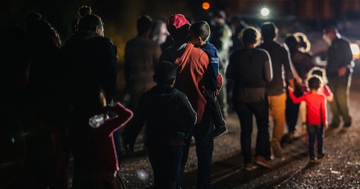 Immigrants seeking asylum walk to be processed and taken to a Border Patrol processing facility after crossing the Rio Grande into the U.S. on June 16, 2021, in Roma, Texas.