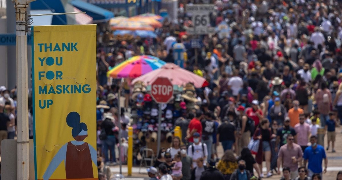People walk near the Santa Monica Pier in Santa Monica, California, on May 31, 2021.