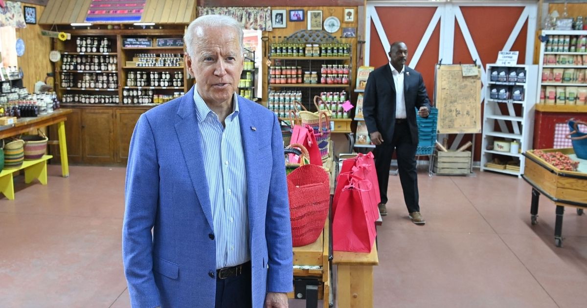 President Joe Biden speaks to reporters in a store in Central Lake, Michigan, on Saturday.
