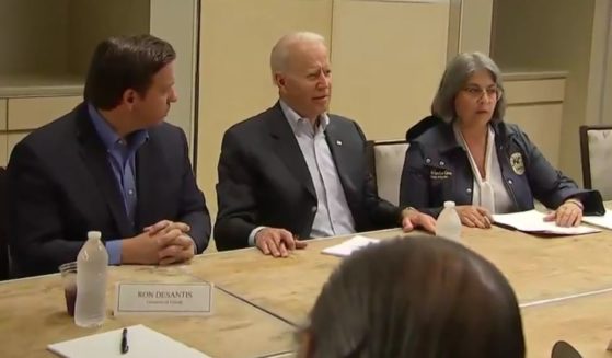 President Joe Biden, center, discusses the emergency situation in Miami, as crews are working to pull people from the rubble of the Champlain Towers South condominium building collapse in Surfside, Florida.