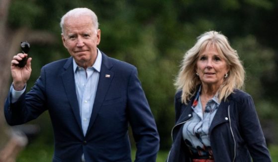 President Joe Biden and first lady Jill Biden walk on the South Lawn upon returning to the White House in Washington, D.C., on Sunday.
