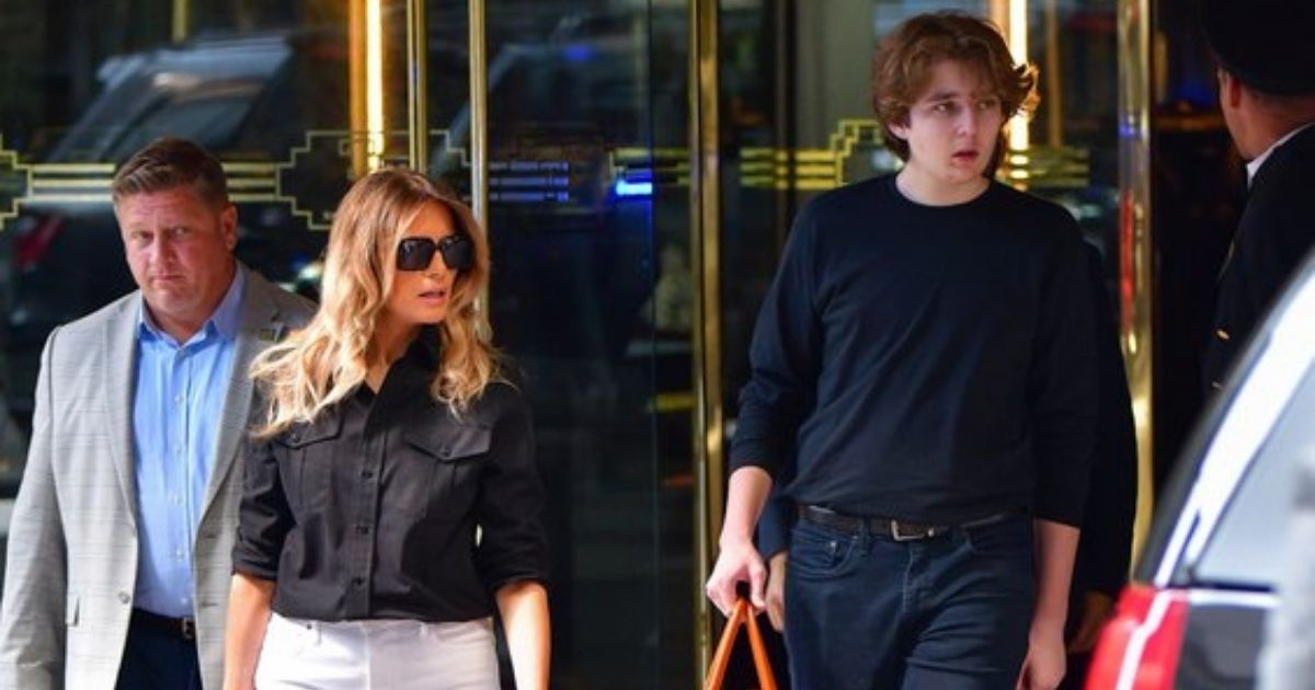 Barron Trump, the 15-year-old son of former President Donald Trump, towers over his mother, former first lady Melania Trump, as they leave the Trump Tower in New York on Wednesday.