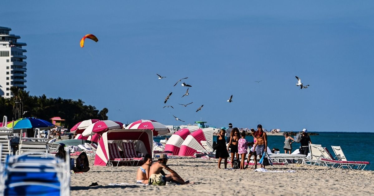People relax on the beach in Miami Beach, Florida, on March 23.