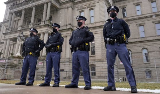 Michigan State Police troopers stand guard outside the state capitol in Lansing on Jan. 17.