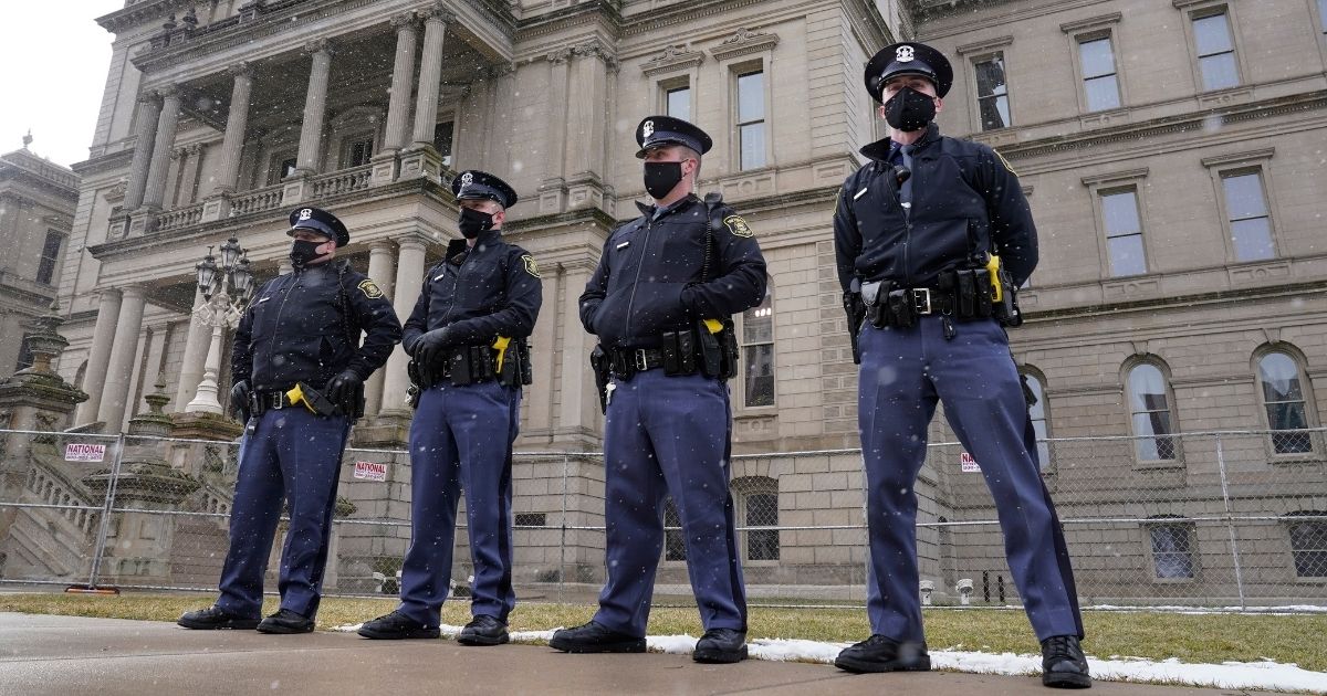 Michigan State Police troopers stand guard outside the state capitol in Lansing on Jan. 17.