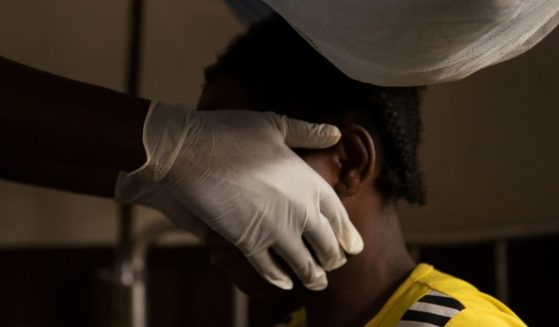 A doctor examines a woman infected with monkeypox at a quarantine area of the centre of the International medical NGO Doctors Without Borders in Zomea Kaka, in the Lobaya region, in the Central African Republic on Oct. 18, 2018.