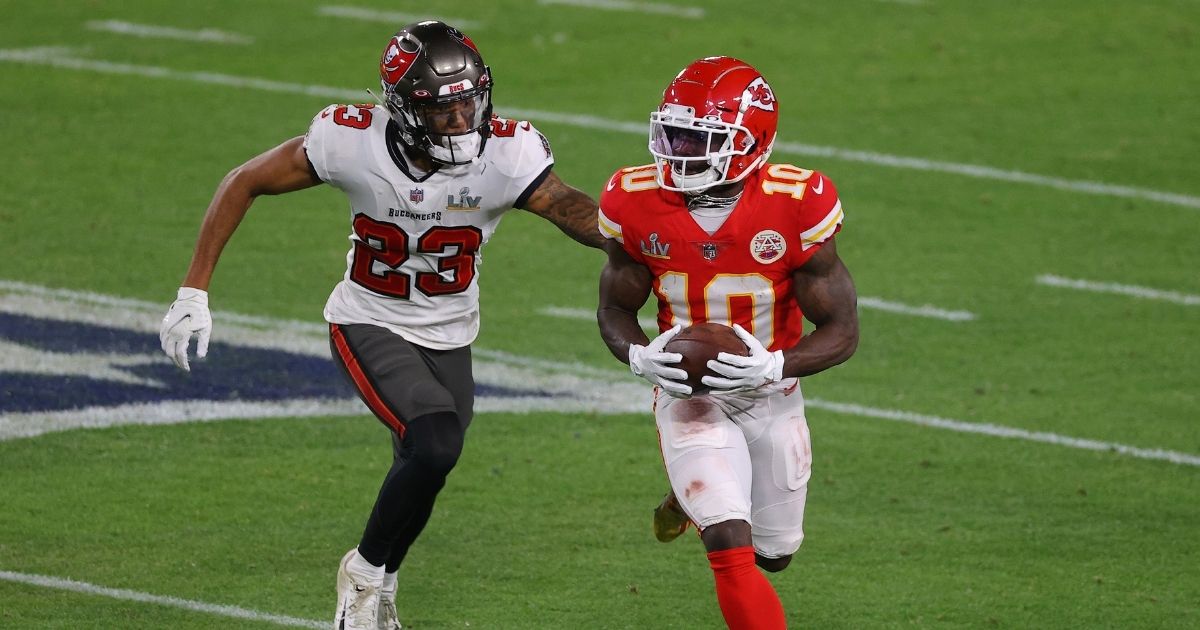 Tyreek Hill, right, of the Kansas City Chiefs rushes ahead of Sean Murphy-Bunting of the Tampa Bay Buccaneers during the third quarter of the game in Super Bowl LV at Raymond James Stadium on Feb. 7, 2021, in Tampa, Florida.