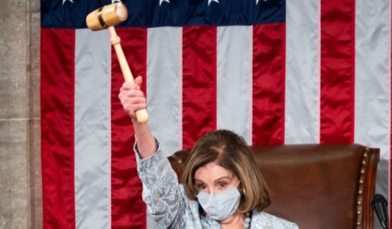 Speaker of the House Nancy Pelosi holds the speaker's gavel in the air on the House floor in the Capitol after becoming Speaker of the 117th Congress on Jan. 3, 2021, in Washington, D.C.