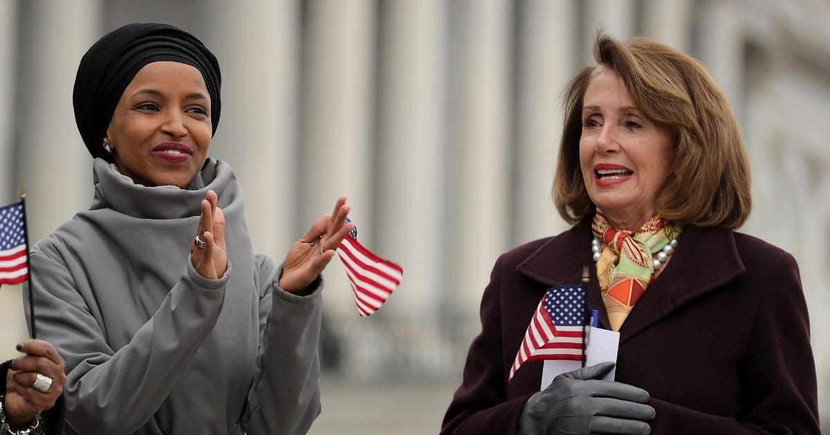 Democratic Rep. Ilhan Omar of Minnesota and Speaker of the House Nancy Pelosi rally with fellow Democrats on the East Steps of the U.S. Capitol on March 8, 2019, in Washington, D.C.