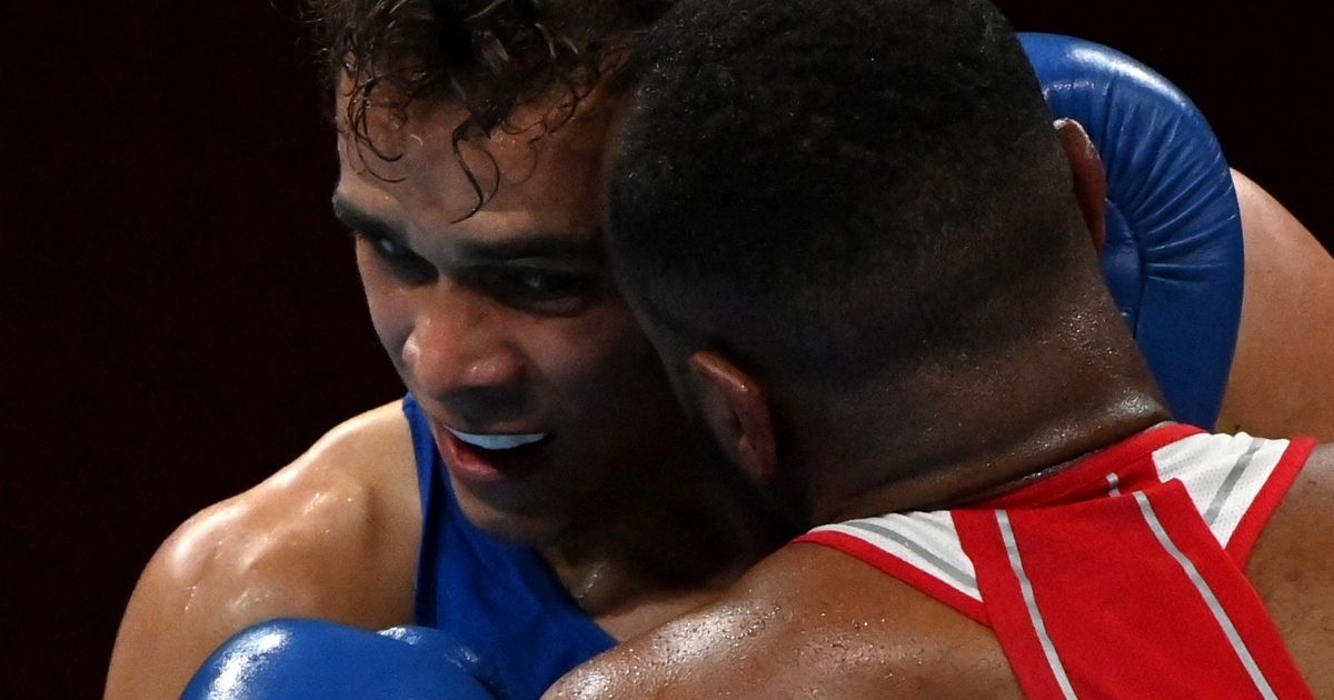 Moroccan boxer Youness Baalla, right, and New Zealand's David Nyika fight in the men's heavy preliminaries of the Tokyo Olympics at the Kokugikan Arena on Tuesday.