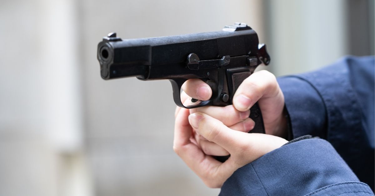 This stock photo portrays a person pointing a pistol. One Texas family reported an armed run-in with a man who was allegedly spying on their 10-year-old daughter.