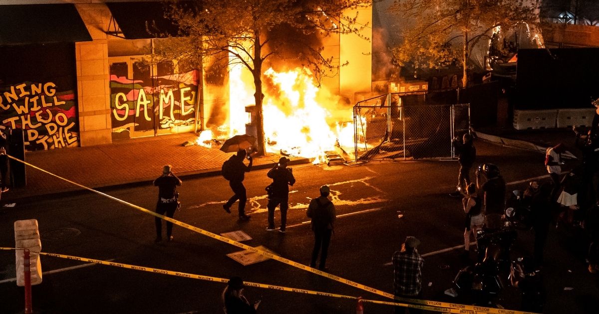 Rioters set fire to a building on April 17, 2021, in Portland, Oregon.