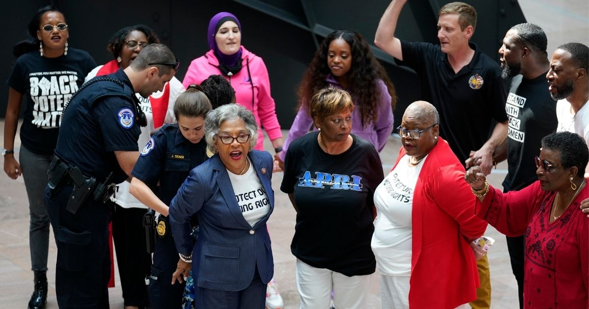 Ohio Democratic Rep. Joyce Beatty, chairwoman of the Congressional Black Caucus, is taken into custody by U.S. Capitol Police officers along with other activists after their incursion of the Hart Senate Office Building on Capitol Hill in Washington on Thursday.