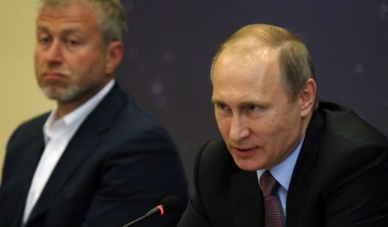 Russian President Vladimir Putin, right, speaks as billionaire and businessman Roman Abramovich looks on during a meeting on July 19, 2016, in Sochi, Russia.