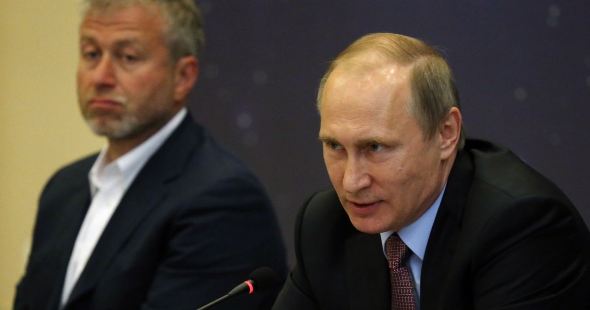 Russian President Vladimir Putin, right, speaks as billionaire and businessman Roman Abramovich looks on during a meeting on July 19, 2016, in Sochi, Russia.