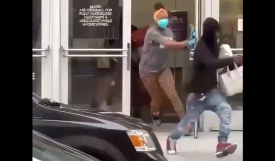 Handbag thieves run from a Neiman Marcus store in San Francisco.
