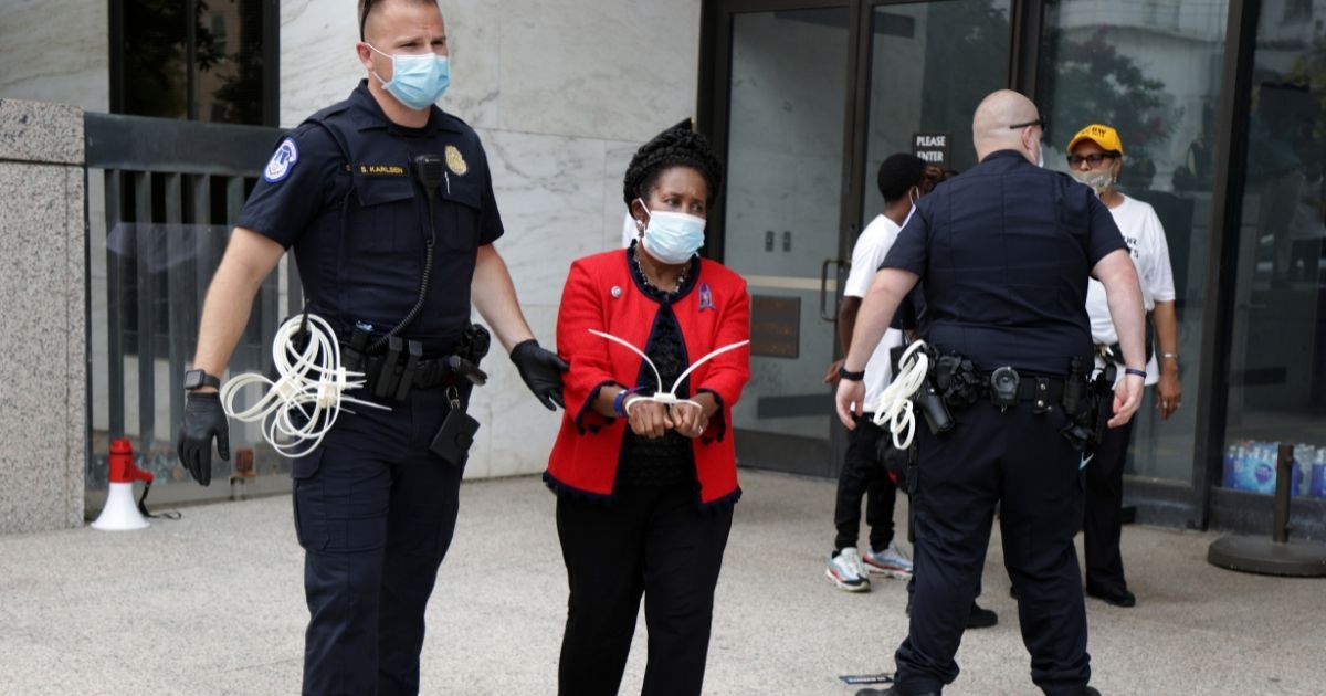 Democratic Rep. Sheila Jackson Lee of Texas is arrested by a member of U.S. Capitol Police during a protest outside Hart Senate Office Building on Capitol Hill on Thursday in Washington, D.C.