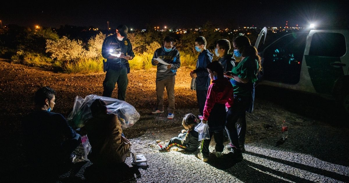 Migrants are accounted for and processed by Border Patrol officers after crossing the Rio Grande into the United States on July 1, 2021, in Roma, Texas.