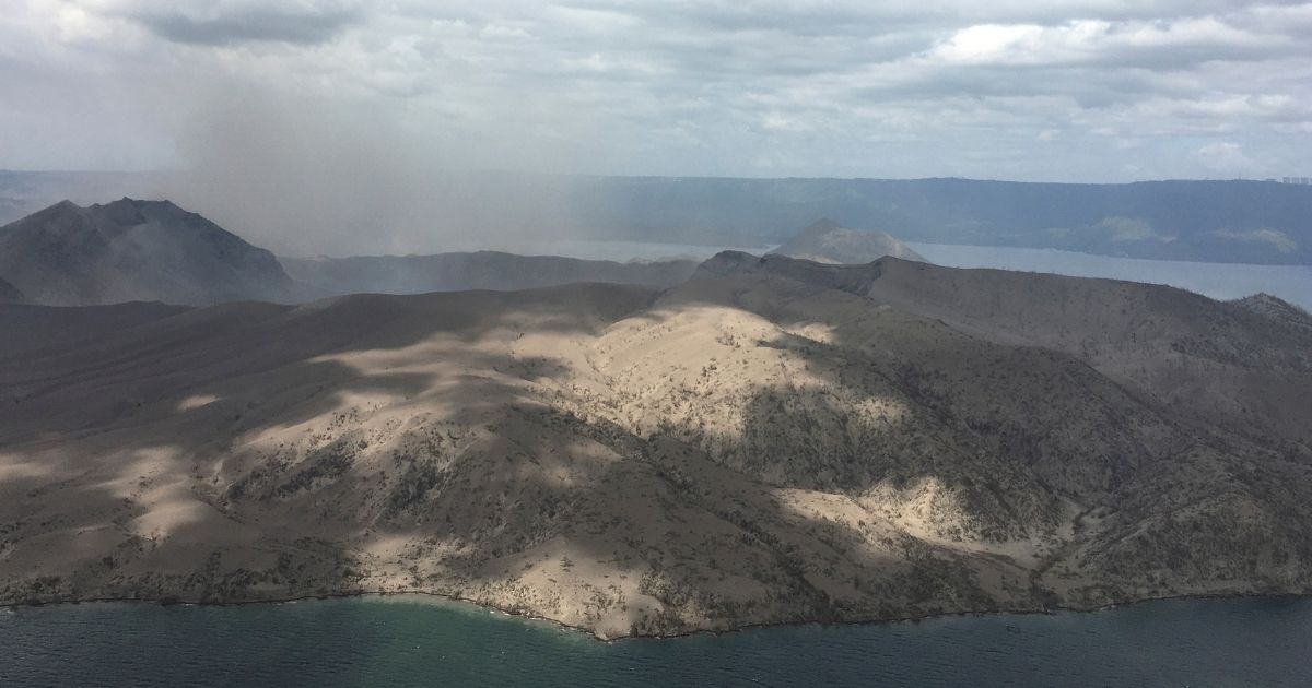 In this Jan. 21, 2020, handout photo provided by the Office of Civil Defense, Taal volcano emits small amounts of ash in Batangas province, southern Philippines.