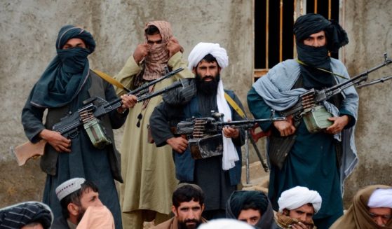 In this Nov. 3, 2015 file photo, Afghan Taliban fighters listen to Mullah Mohammed Rasool, the newly-elected leader of a breakaway faction of the Taliban, in Farah province, Afghanistan.