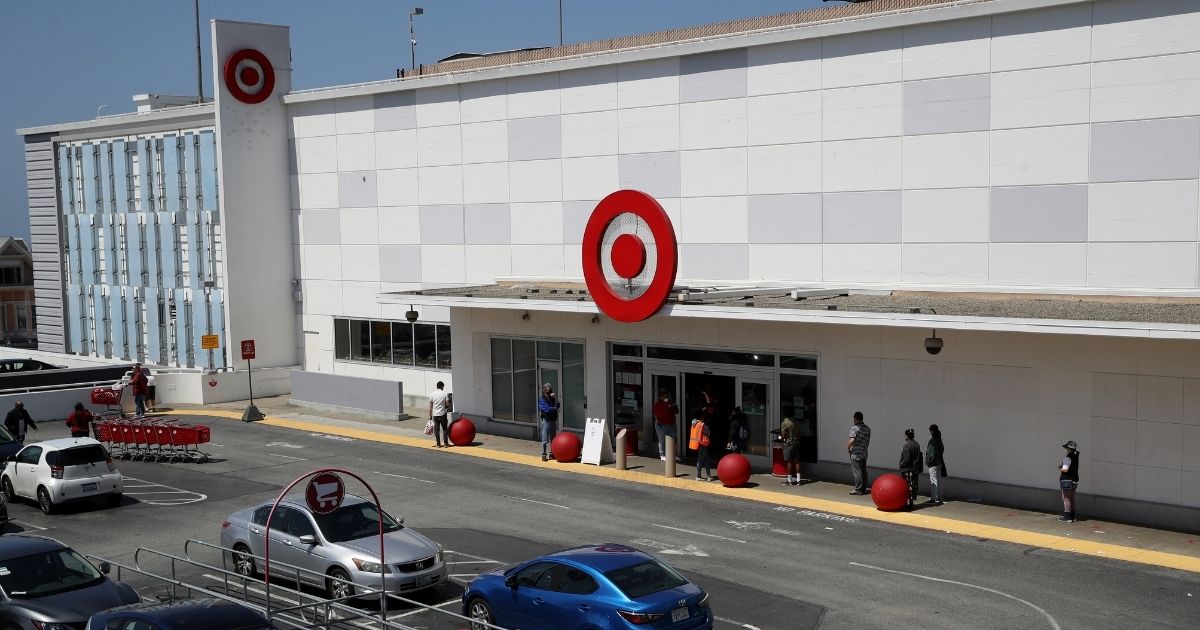 In this aerial view from a drone, people wait in line to enter a Target store on April 13, 2020 in San Francisco, California.