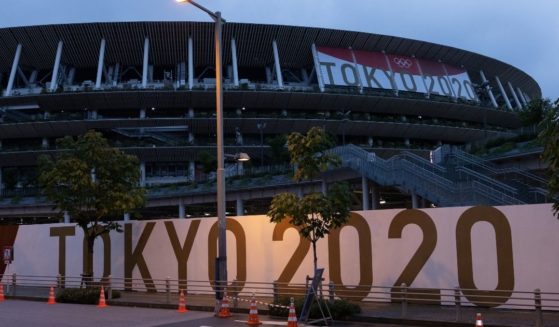 Branding is displayed on a fence surrounding the Olympic Stadium on Thursday in Tokyo, Japan.