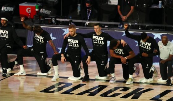 Brooklyn Nets players kneel for the national anthem before action against the Toronto Raptors in game four of the first round of the NBA playoffs at The Field House at ESPN Wide World Of Sports Complex on Aug. 23, 2020, in Lake Buena Vista, Florida.