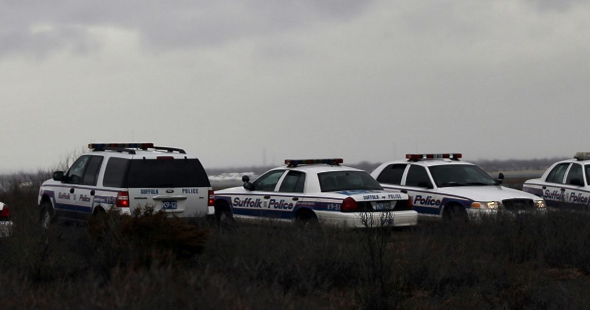 Suffolk County Police cars involved in a search effort are parked on the side of the road along a stretch of beach highway on April 5, 2011, in Babylon, New York.
