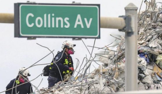 A rescue team is seen walking through the debris at the Champlain Towers South Condo in Surfside, Florida, on July 7.