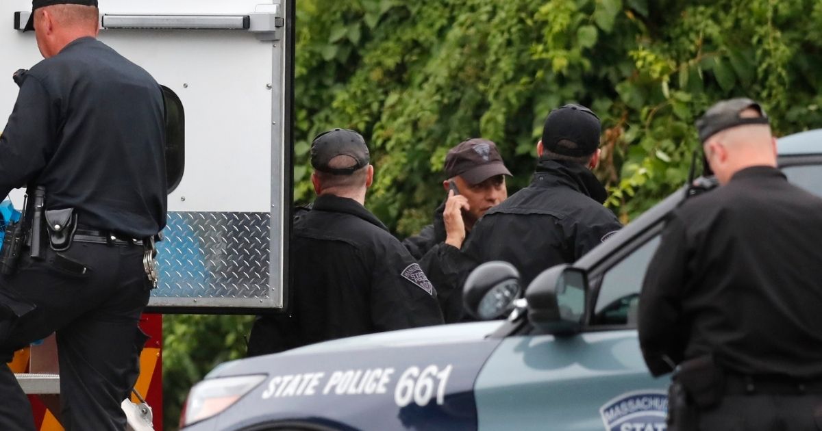 Massachusetts state police on the scene of Saturday's standoff with a group of heavily armed men along Interstate 95.