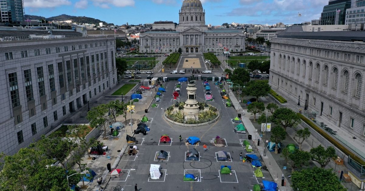 An aerial view shows a tent encampment for the homeless in San Francisco on May 18, 2020. The camp provides a sleeping area in a fenced-off space near City Hall with marked spots for tents that practice social distancing.