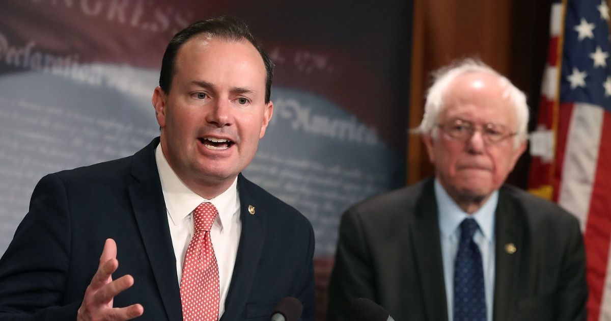 Republican Sen. Mike Lee of Utah is pictured with independent Sen. Bernie Sanders at a 2018 news conference.