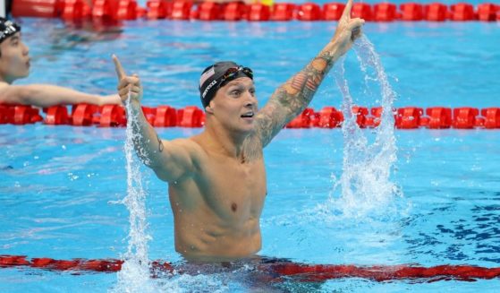 Team USA swimmer Caeleb Dressel celebrates Thursday after winning the gold medal in the men's 100-meter at the Tokyo 2020 Olympic Games.