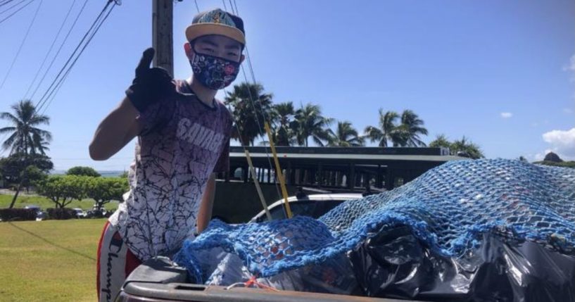 Genshu Price stands on the back of a truck after loading it with recyclable cans and bottles from Kualoa Ranch in Kāne'ohe, Hawaii, for his fundraiser, Bottles4College, in May.