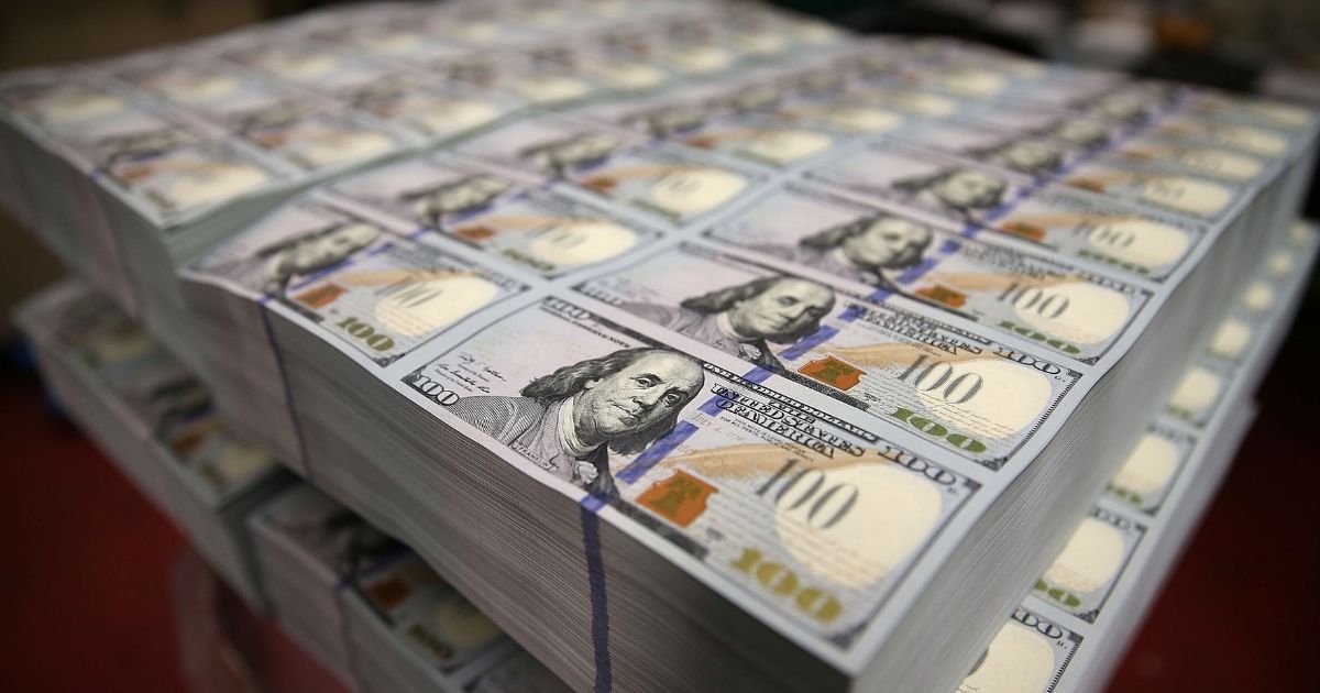 A bundle of $100 bills is seen lying in a stack at the Bureau of Engraving and Printing at Washington, D.C., in this photo taken on May 20, 2013.
