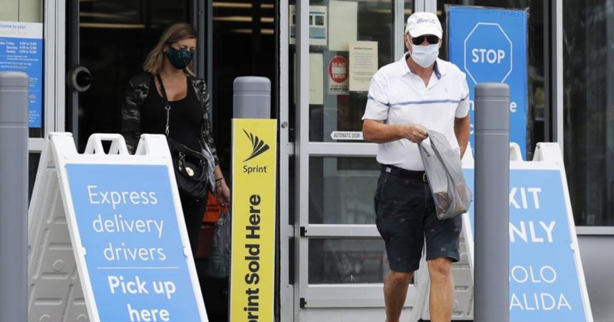 Shoppers are seen wearing face masks as they exit a Walmart store in Vernon Hills, Illinois, in this photo taken on Friday.