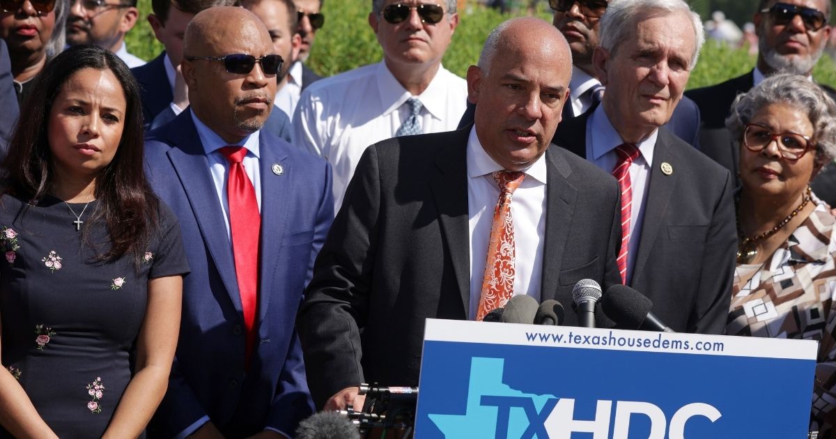 Flanked by Texas state House Democrats, Texas State Rep. Chris Turner, chair of the Texas House Democratic Caucus, speaks as U.S. Rep. Marc Veasey, back row, and U.S. Rep. Lloyd Doggett listen during a news conference outside the U.S. Capitol last week in Washington, D.C.