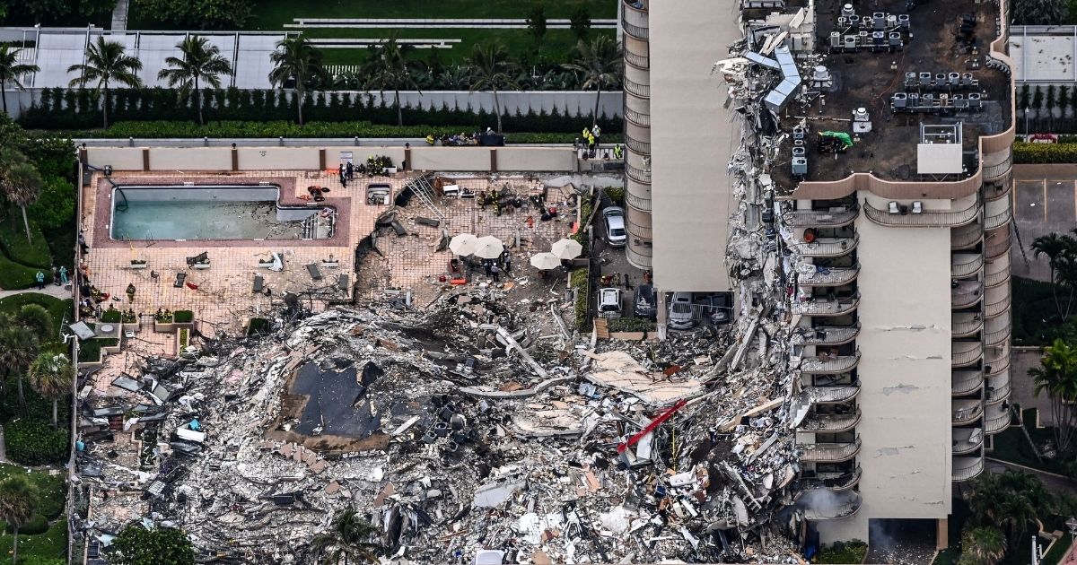 This aerial view shows search and rescue personnel working on site after the partial collapse of the Champlain Towers South in Surfside, north of Miami Beach, on June 24, 2021.