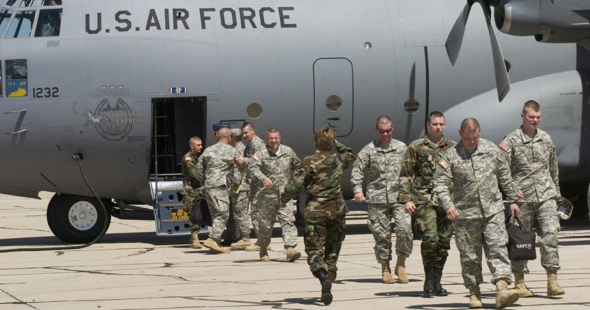 Members of the Kentucky National Guard 206th Engineer battalion arrive by C-130 Hercules transport plane on July 11, 2006, in Tucson, Arizona.