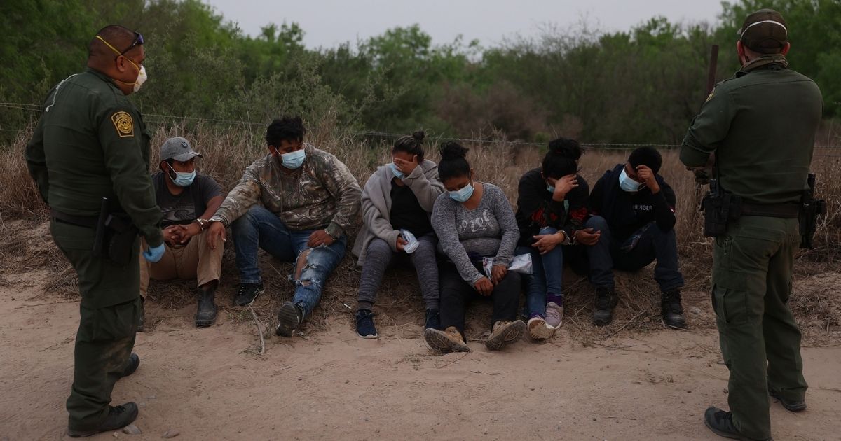 U.S. Border Patrol agents process a group of people they caught crossing the border from Mexico on March 27, in Penitas, Texas.