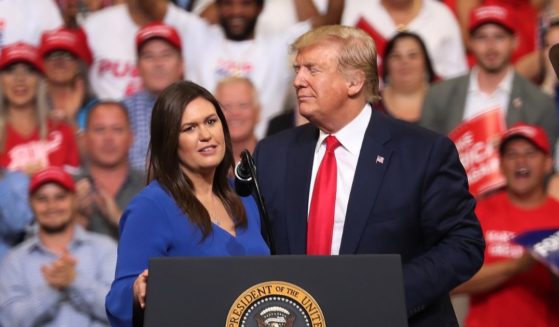 Then-President Donald Trump stands with Sarah Huckabee Sanders at the Amway Center on June 18, 2019, in Orlando, Florida.