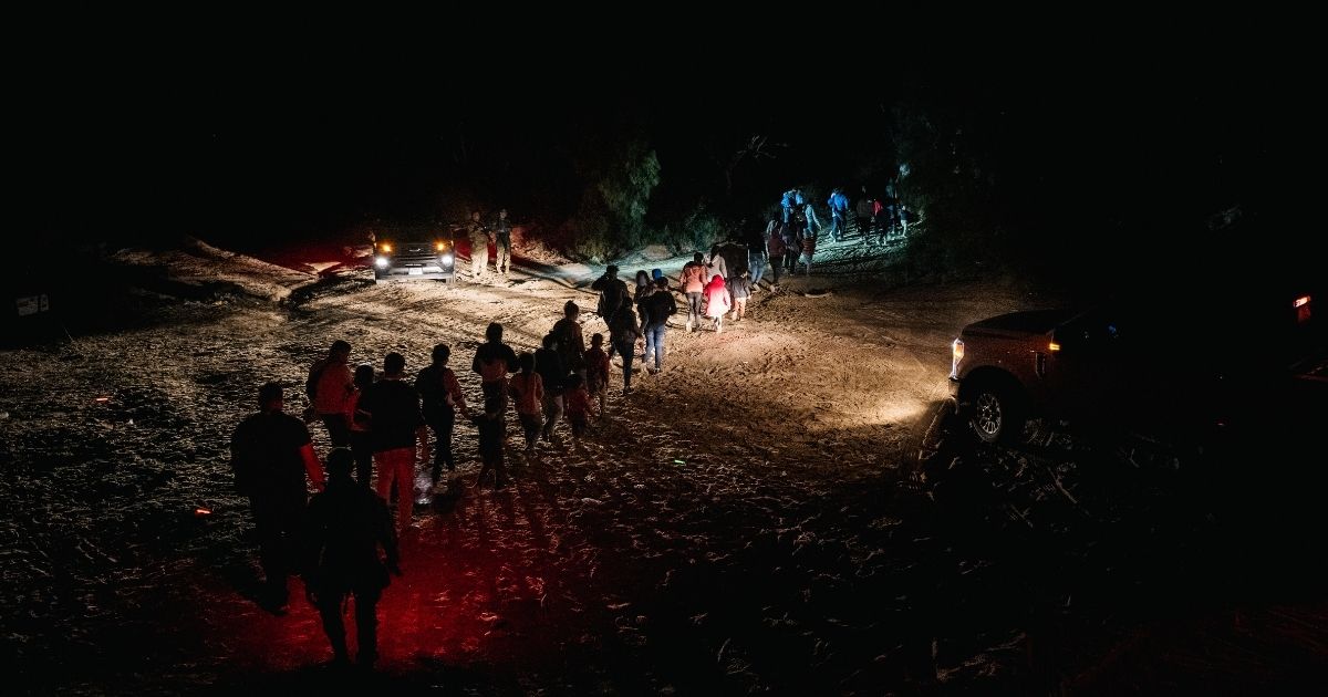 Border Patrol processes a group of migrants in Roma, Texas, after they illegally crossed the Rio Grande on Monday.