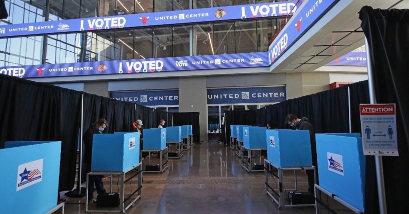 Voters use socially distanced voting machines set up in the east atrium of the United Center where a polling place with 70 machines was set up for the first time on Nov. 03, 2020, in Chicago.