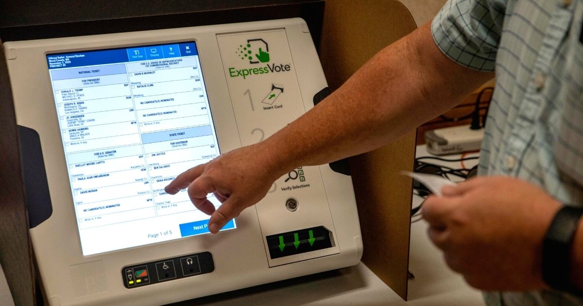 Mark Rhodes, county clerk of Wood County, West Virginia, shows the process of voting using new machines in Parkersburg on Oct. 21, 2020.