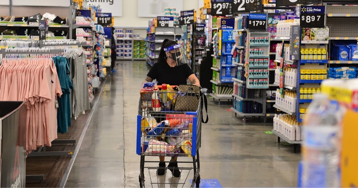 Customers wearing face masks shop at a Walmart retail store on July 16, 2020, in Pembroke Pines, Florida.